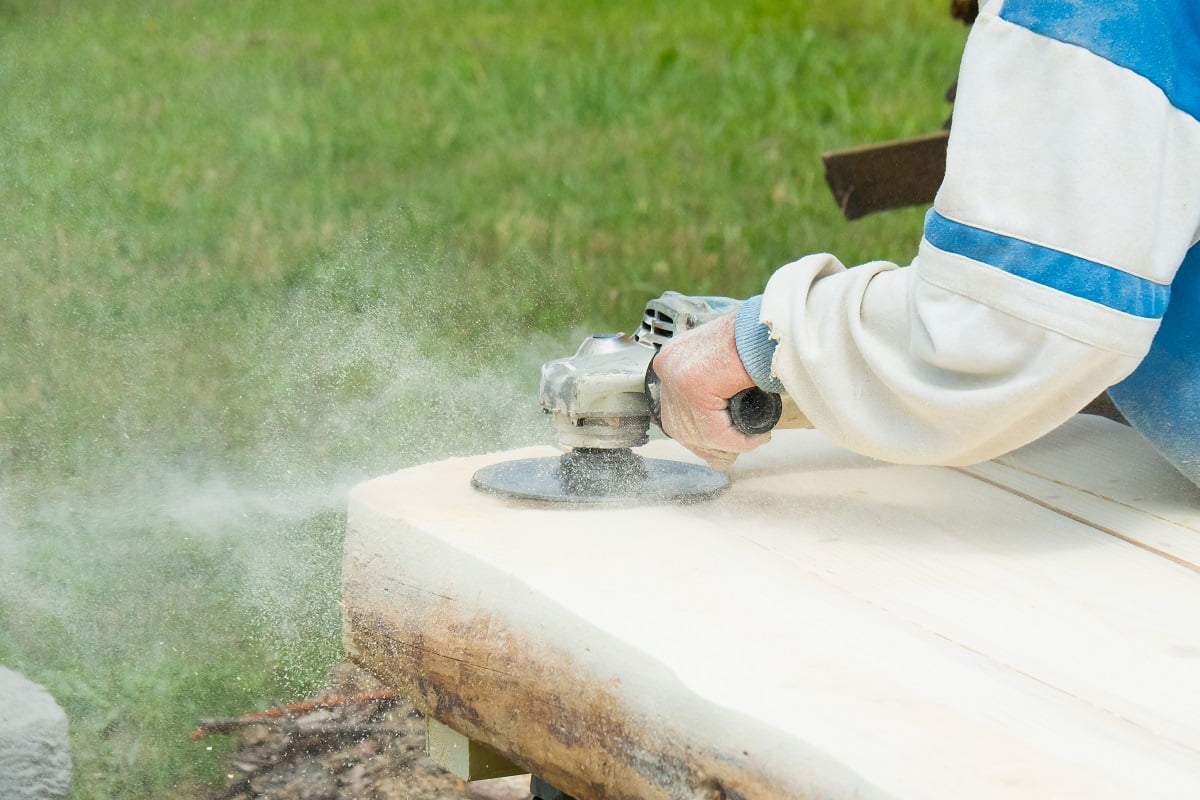 Sanding wood. Working with a sander. Dust clouds. Can Angle Grinders Cut Wood.