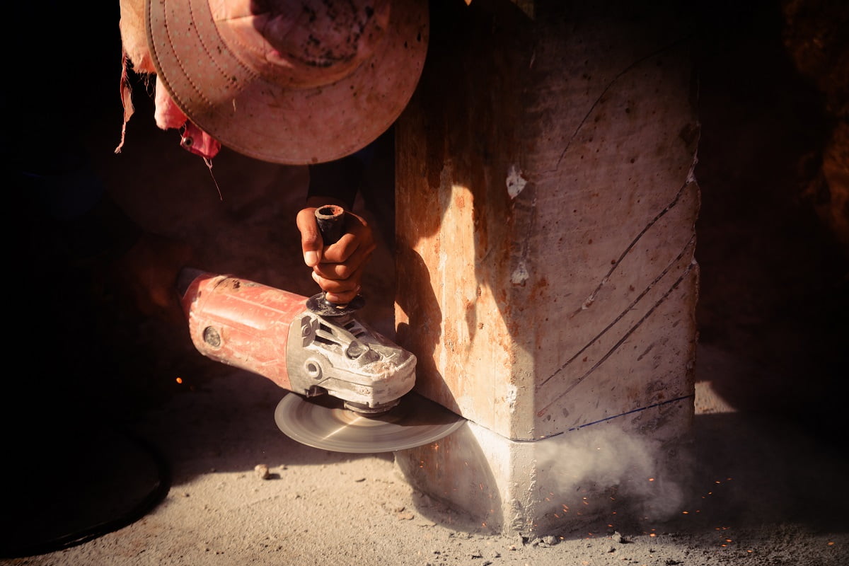 Industry construction labor men worker holding electric saw cuting concrete. What Angle Grinder Blade For Concrete.