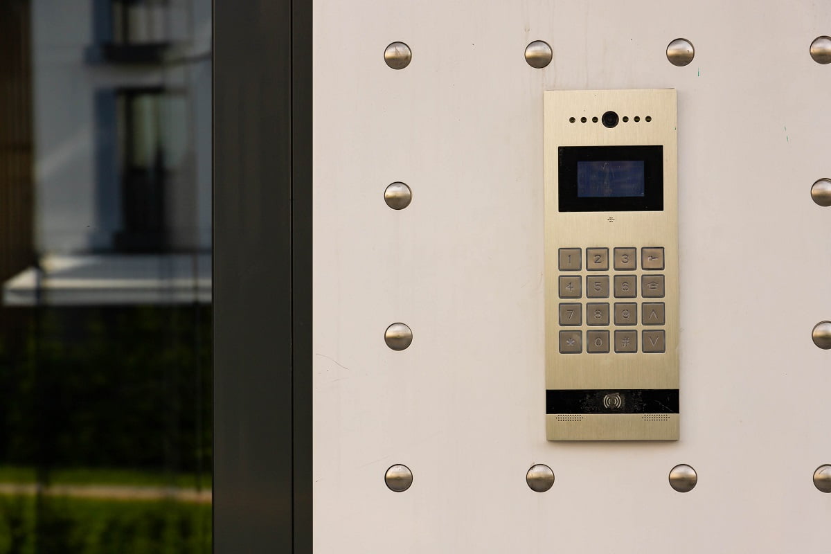 Closeup of the intercom in new build residential building. Wired Vs Wireless Doorbell Installations.