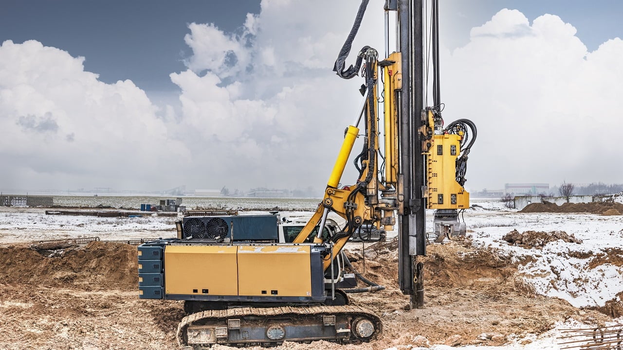 A powerful drilling rig for peeling at a construction site. Operation of the drilling rig in northern conditions. Pile foundations. Bored piles. Drills.