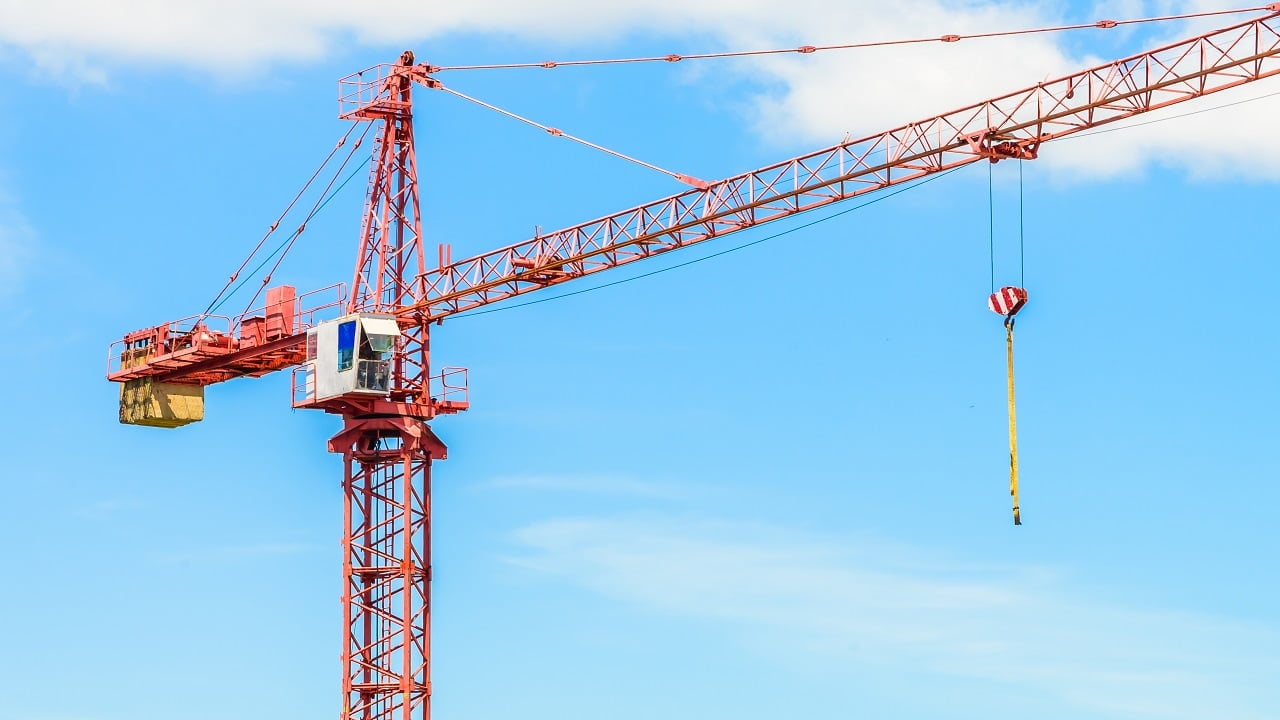 Construction site building on blue sky background. Tower Cranes.