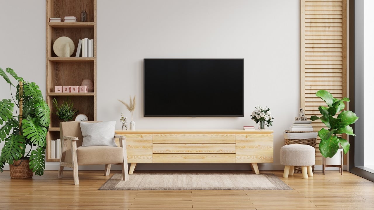 TV cabinet on the white wall in living room with armchair,minimal design. Fit Your TV Flush To The Wall.