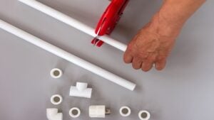 Plastic pipes for the water system on grey background. Repair service, sale, online. Flat lay. Copy space 50 DIY PVC Pipe Projects You Can Do Today