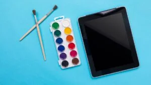 Watercolor paintbox. Color paints with paint brushes isolated on blue background as part of kids painting education concept. Cheap Drawing Tablets Conclusion