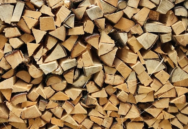 Split firewood heap stacked chopped timber wood. Hickory