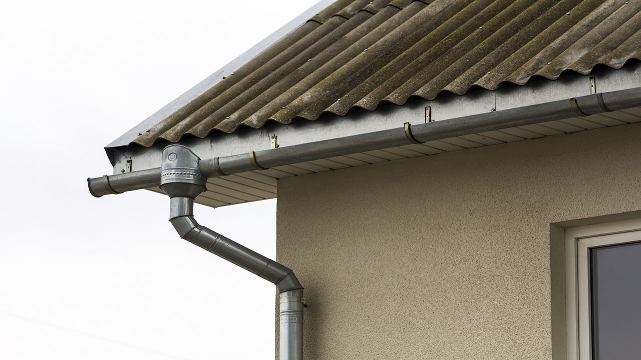 Corner of a house with a steel gutter system. My Two Favourite Methods For Managing Runoff.