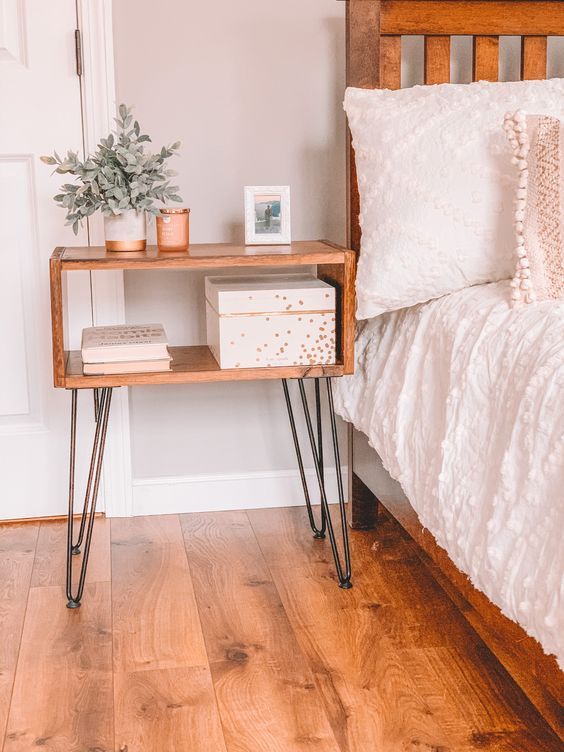 Slim narrow nightstand with hairpin legs beside bed